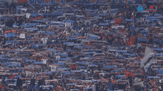 a crowd of people in a stadium with a sign that says ' lyon ' on it