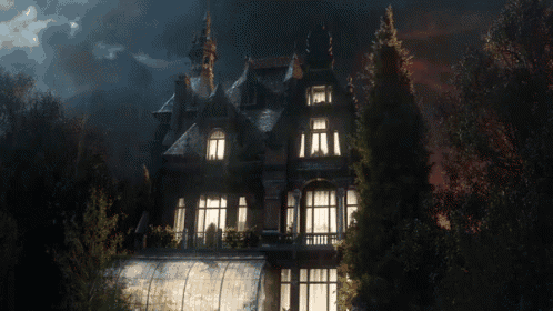 a large house is lit up at night