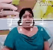 a woman in a blue shirt is singing into a microphone with music notes in the background .