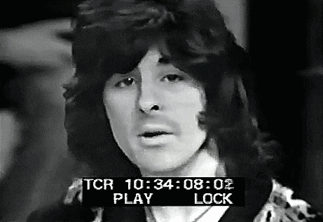 a black and white photo of a man with long hair and a time stamp that says tcr .