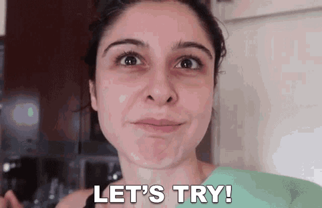 a woman is making a face and says let 's try