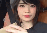 a close up of a woman 's face with a hand on her chin .