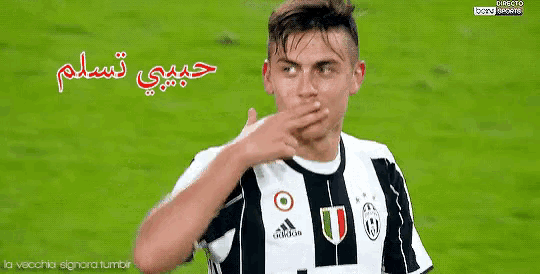 a soccer player covering his mouth with his hand while wearing a adidas jersey