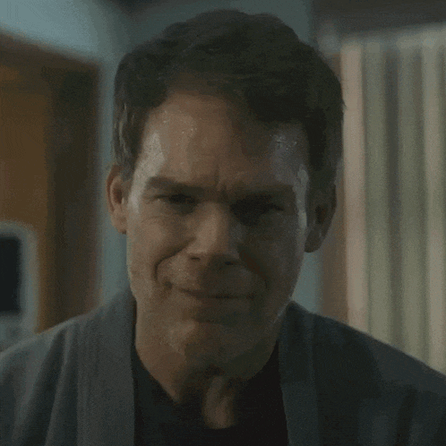 a close up of a man 's face with sweat running down his forehead