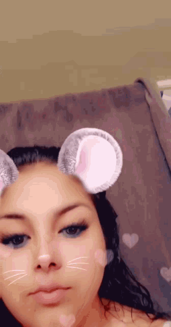 a woman wearing a mouse ear filter on her face