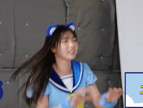 a girl in a blue sailor outfit with a bear headband