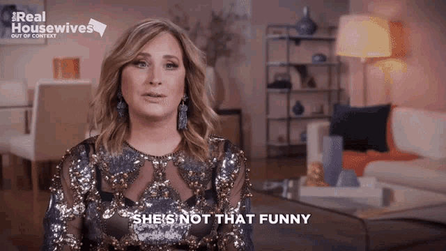 a woman says she 's not that funny in front of a sign that says real housewives