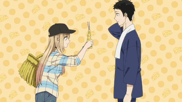 a man and a woman are standing next to each other in front of a yellow polka dot background