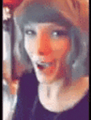 a close up of a woman 's face with a surprised expression .