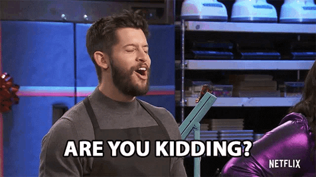 a man with a beard is saying " are you kidding " while wearing an apron