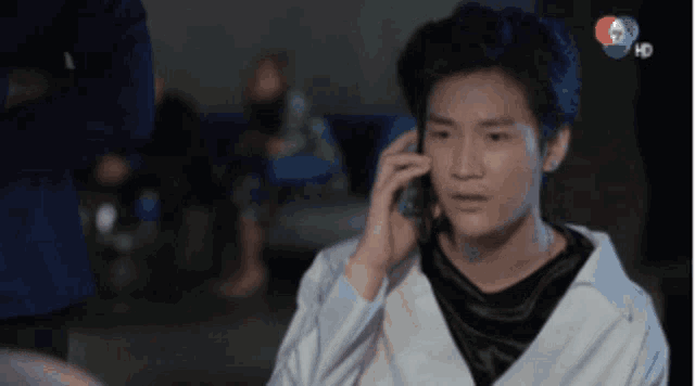 a young man talking on a cell phone with a hd logo on the bottom right