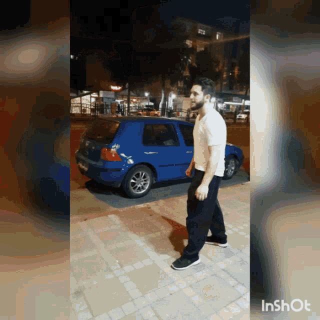 a man is walking in front of a blue car and the word inshot is on the bottom right
