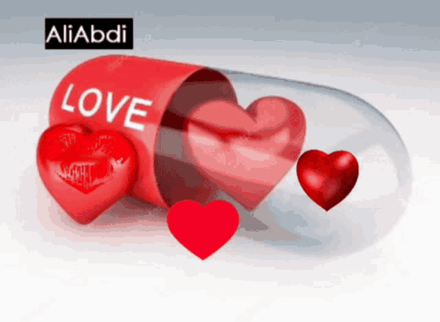 a capsule with the word love on it and three hearts inside