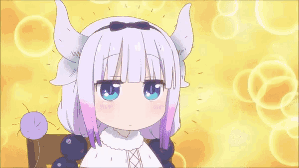 a girl with horns and a bow on her head is sitting on a chair .