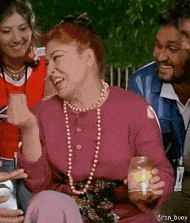 a woman wearing a pearl necklace is laughing while holding a jar of food .