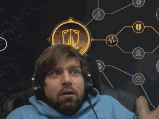 a man wearing headphones is holding a stuffed animal on top of his head