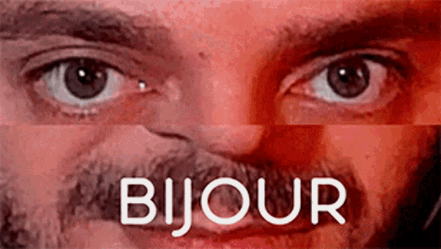 a close up of a man 's eyes and mouth with the word bijou written above them .
