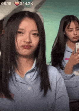 two girls are standing next to each other and one is wearing a headband with bunny ears