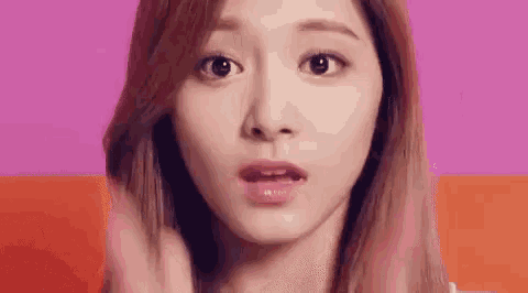 a close up of a woman 's face making a surprised face .