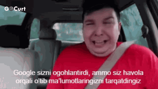 a man in a red shirt is sitting in the back seat of a car with a caption that says gocurt