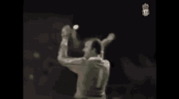 a blurred image of a man in a green jersey with the number 1 on it