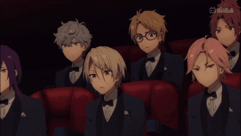 a group of anime characters are sitting in a theater with a bilibili logo in the upper right corner