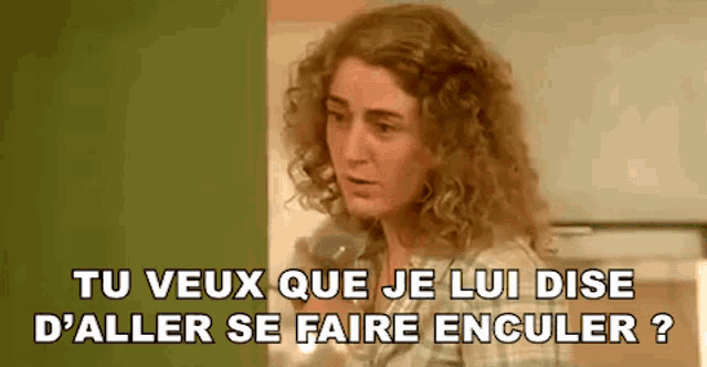 a woman with curly hair is talking on a phone and says tu veux que je lui dise