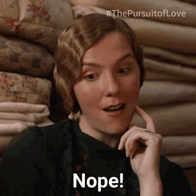 a woman says nope in front of a stack of blankets