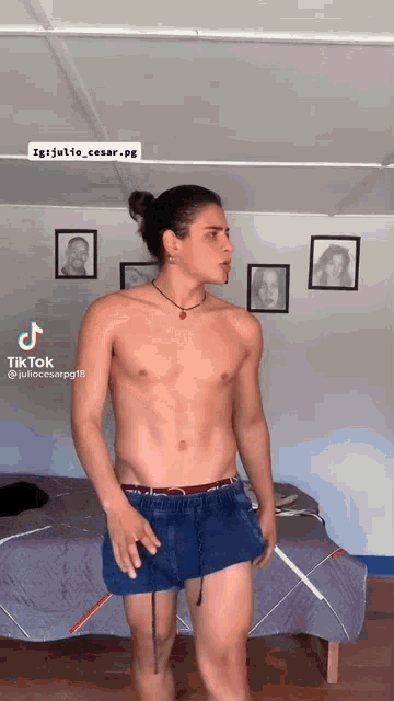 a man without a shirt is standing in front of a bed with a tiktok watermark
