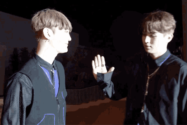 two men are giving each other a high five