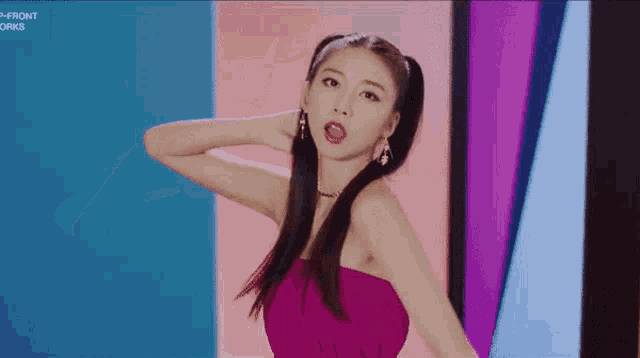 a woman in a pink dress is standing in front of a screen that says front works