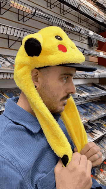 a man wearing a yellow hat with a pikachu face