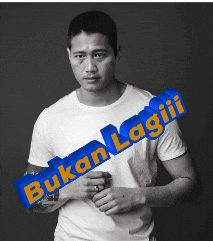 a man in a white shirt has a blue sign that says bukan lagiii