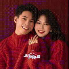 a man and a woman in red sweaters are posing for a picture .