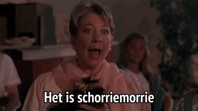 a woman in a pink scarf with het is schorriemorrie written below her