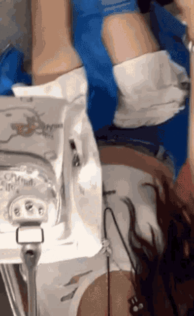 a woman is laying in a hospital bed with a stethoscope on her stomach .
