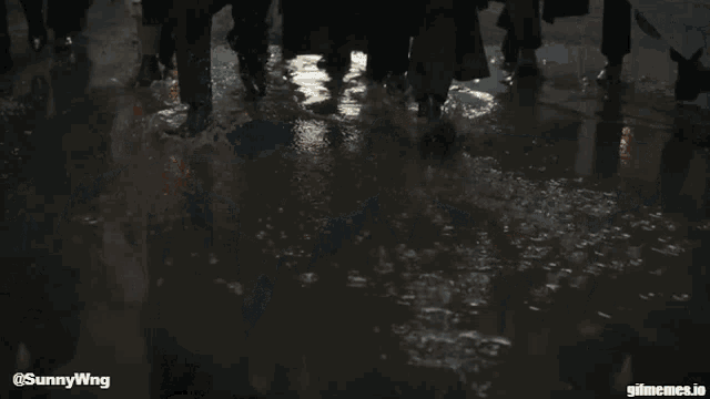 a group of men wearing suits and masks are walking down a street with a watermark that says sunnywing