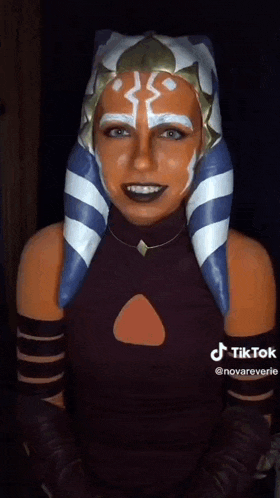 a woman in a star wars costume is making a tiktok video .