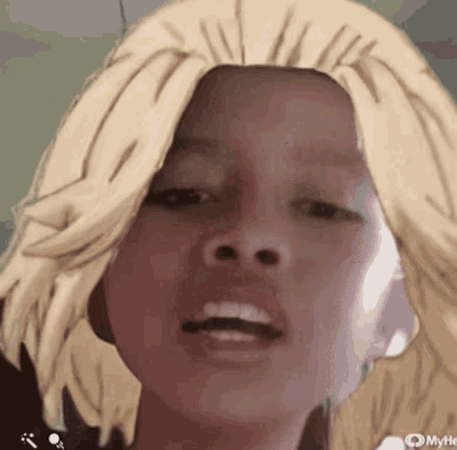 a close up of a child 's face with a wig on it