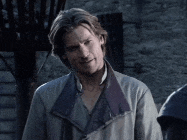 a man in a grey jacket with a blue collar