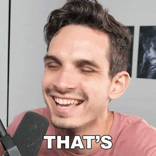 a man in a pink shirt says that 's while smiling