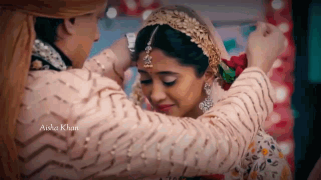 a man is putting a flower on the head of a bride