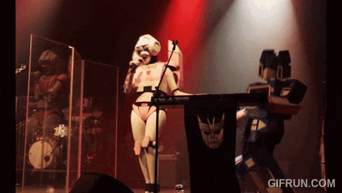 a robot playing a keyboard with gifrun.com written on the bottom right
