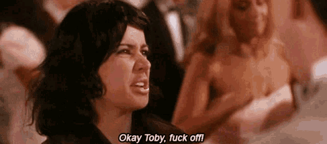 a woman is making a funny face and saying okay toby , fuck off !