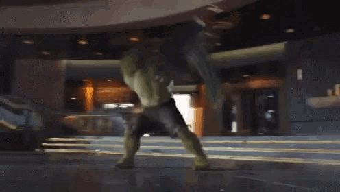 the hulk is standing in front of a building with a staircase