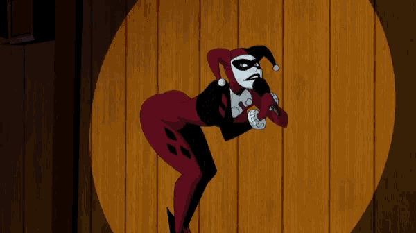 a harley quinn cartoon character standing in front of a wooden wall