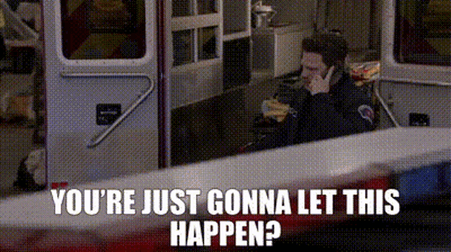 a man is talking on a cell phone in front of an ambulance with the words " you 're just gonna let this happen "