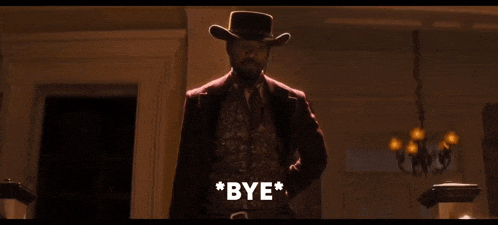 a man in a cowboy hat holds a gun and says bye in front of a group of people