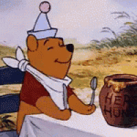 winnie the pooh is sitting at a table holding a spoon in front of a pot of honey