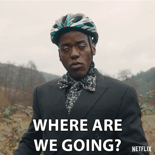 a man wearing a suit and a bicycle helmet is asking where are we going